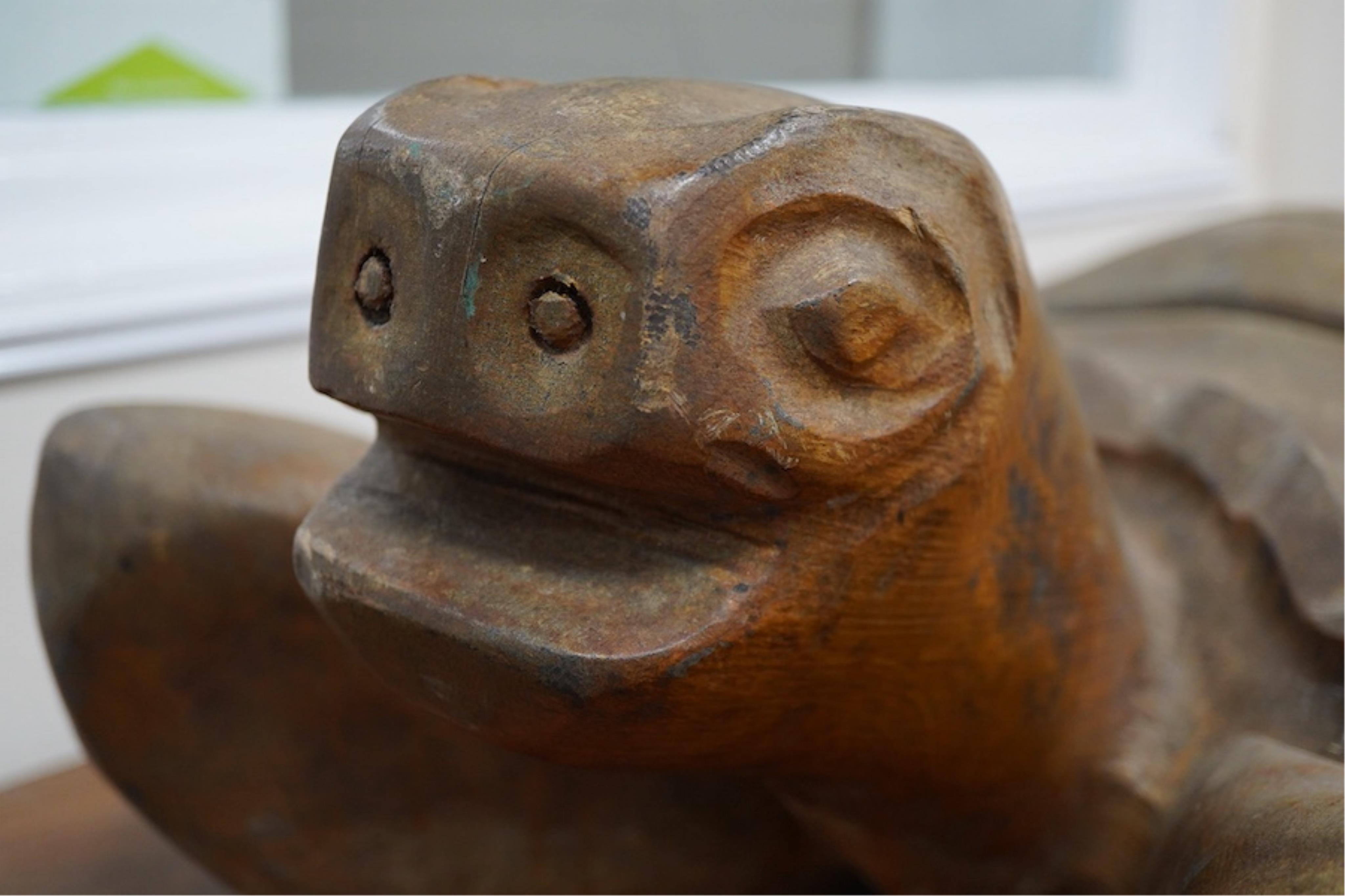 A large novelty carved weathered teak model of a green turtle